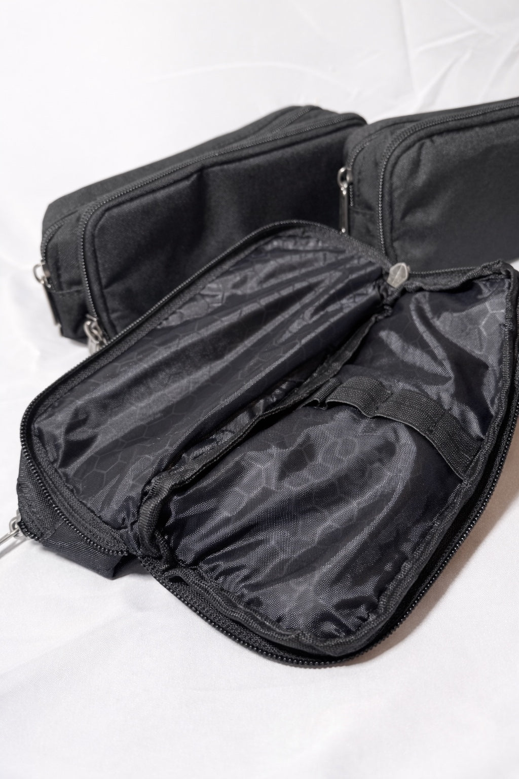 Black zip organiser case open showing interior compartments