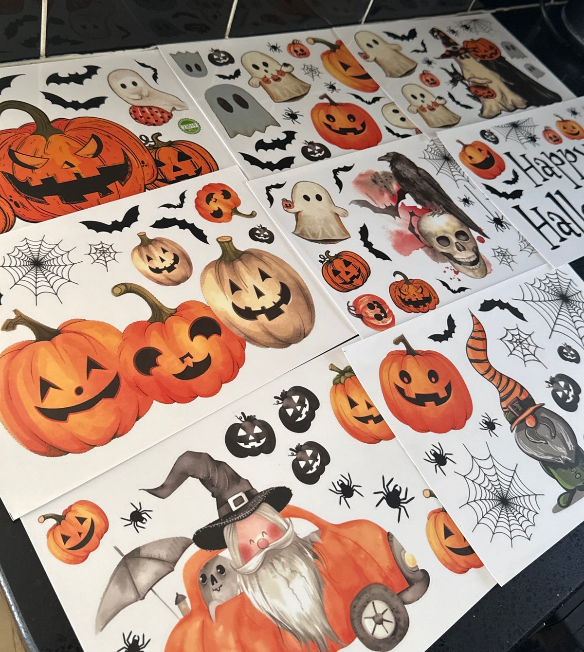 Close-up of Halloween stickers featuring pumpkins, bats, webs and seasonal characters