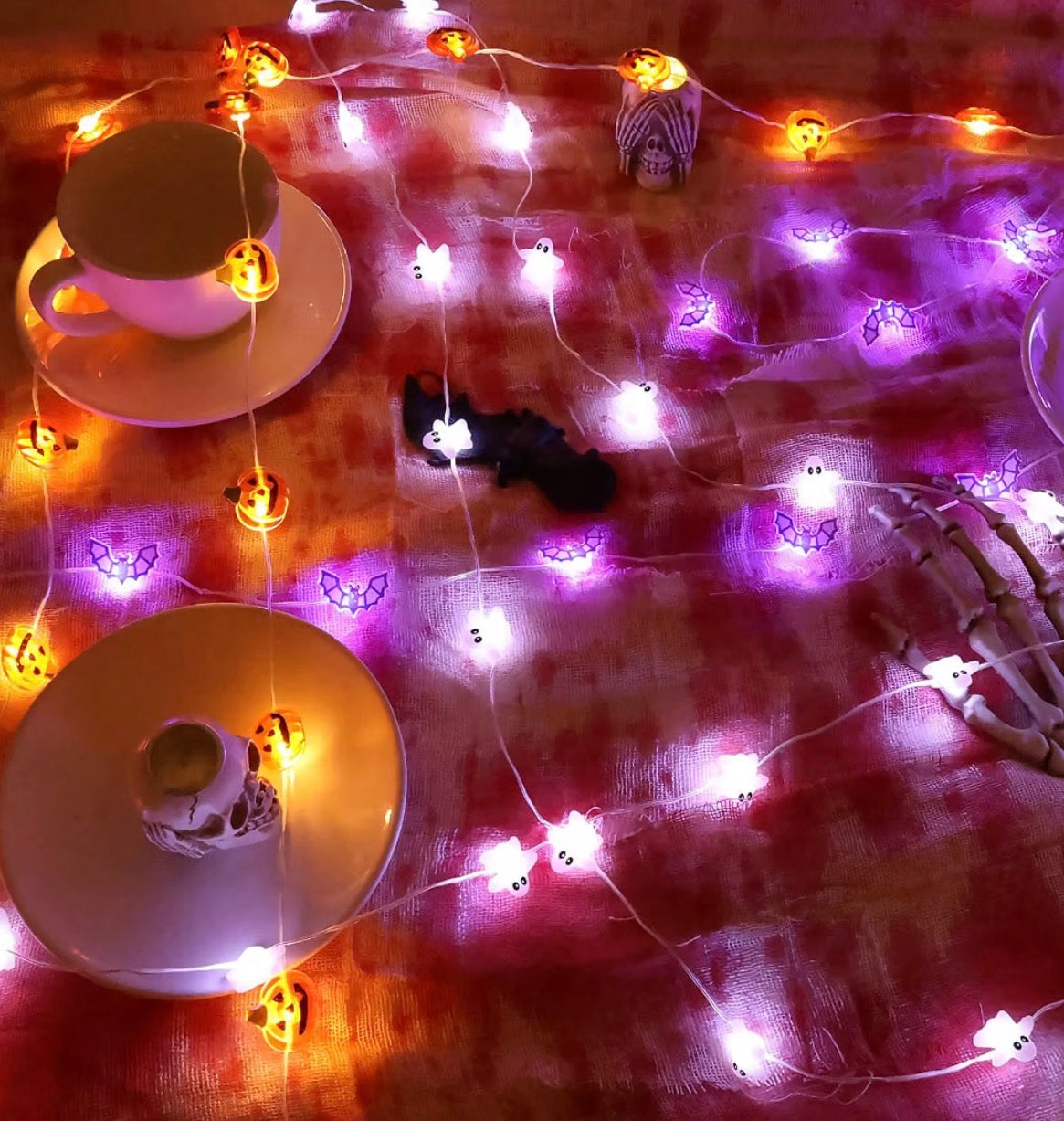 Halloween pumpkin ghost and purple string lights displayed