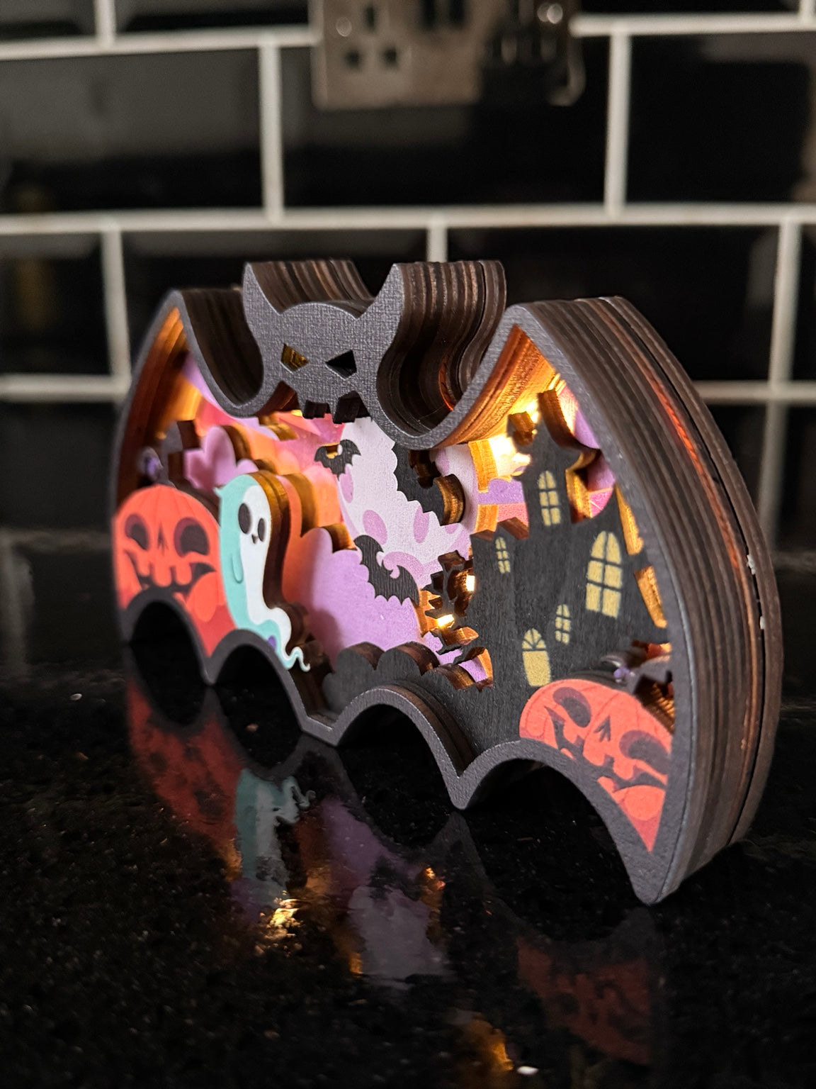 Side view showing the layered construction of the light-up Halloween bat decoration